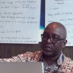 Foday Bassie Swaray , profile photo of man pointing at laptop